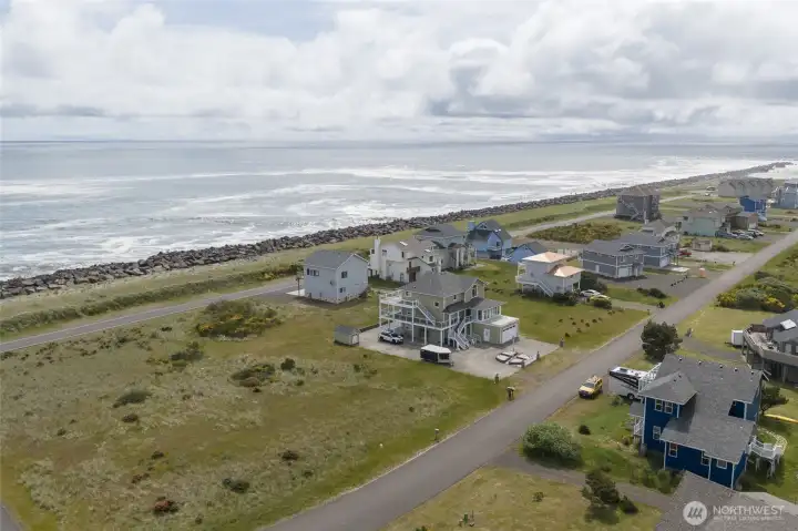 Aerial view of the home in the Center with views of the Rock Jetty and Pacific Ocean to the West