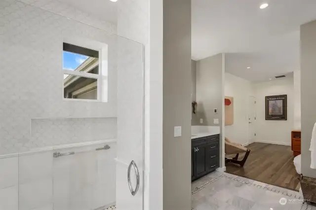 We love the floor to ceiling marble tile. To the right is a gorgeous walk-in custom closet.