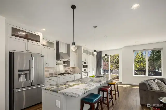 The kitchen is a chef's dream with gleaming white cabinetry, professional grade appliances, gorgeous marble countertops and magazine ready finishes.  Bosch oven, steam oven, and dishwasher, gas cooktop and LG refrigerator.