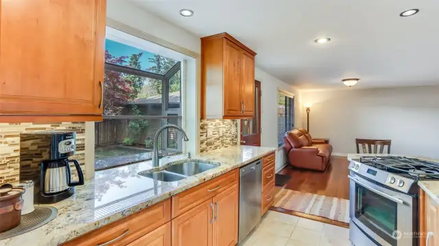 Ample counter space with the marble countertops, tiled floors and recessed lighting.