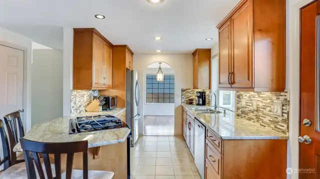 This beautiful kitchen also features ample storage, tiled backsplash & undermount sink.