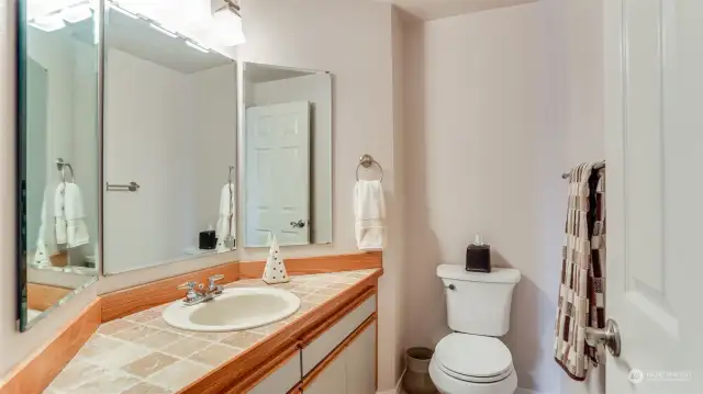 Situated next to the main living areas is a half bath.