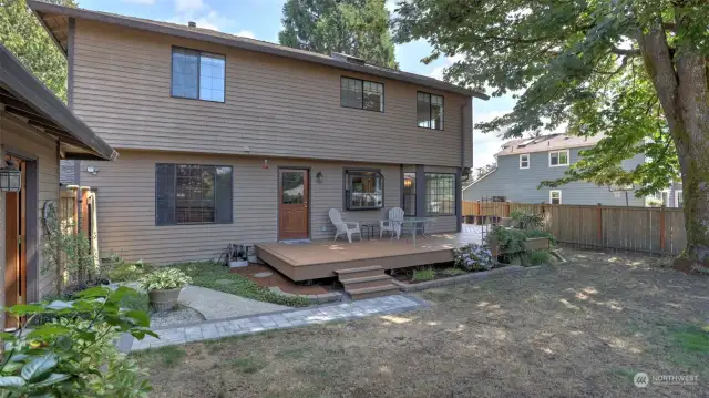 The curb appeal extends to the backyard with the landscaping and paver walkways.