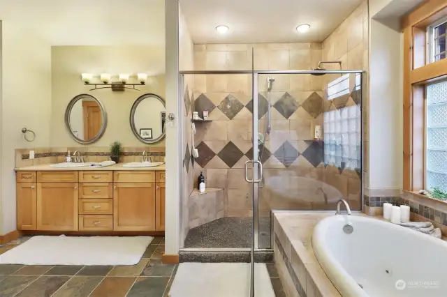 Relax in the soaker tub & relish the large, walk-in shower with stone tile walls and rainfall fixtures.