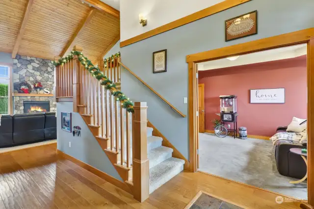 Welcome to our home! Engineered distressed oak floors are featured in the foyer & kitchen. To the right, a spacious den. An open staircase accesses the upper level bedrooms.