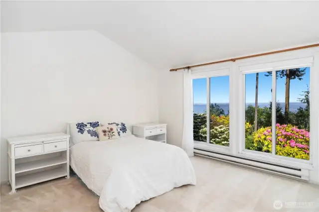The Primary bedroom has room for a King Size bed. The shades on the windows are very nice as they afford privacy and allow light. An expensive upgrade.