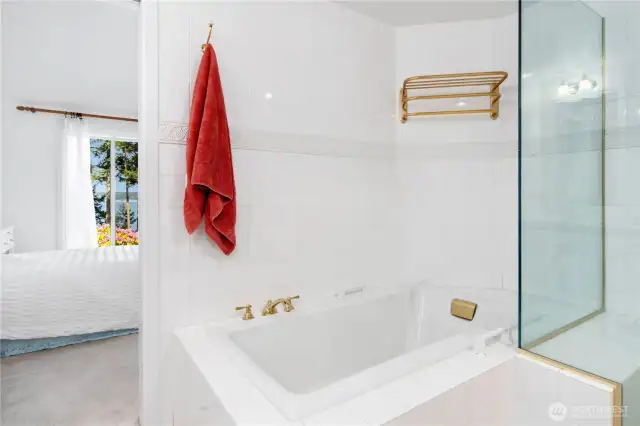 Large soaking tub and glass shower.