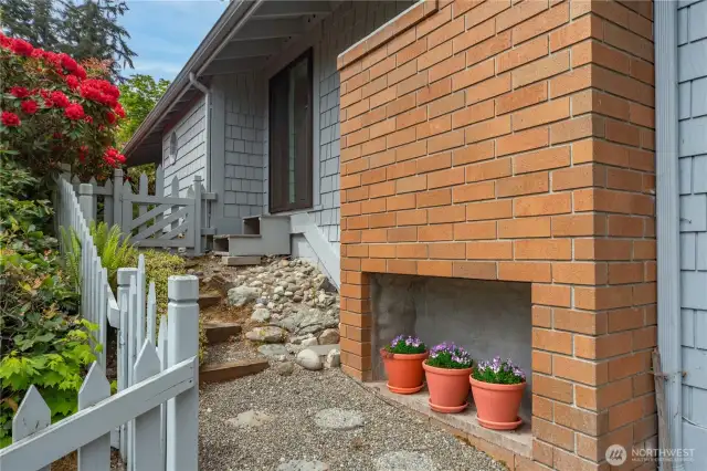 The side of the Living room fireplace and entry to the back patio and yard the is totally private.