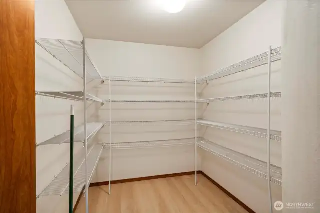 A spacious walk-in pantry offers plenty of room for all your kitchen essentials.