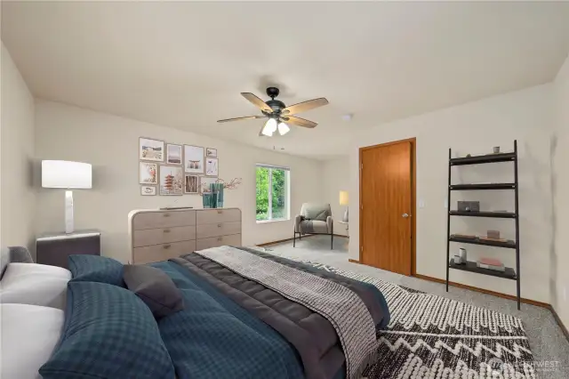 Retreat to the generously sized primary suite, featuring plenty of room for chairs or a quiet lounging space.