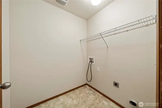 Spacious utility room conveniently located on the upper level with all bedrooms.