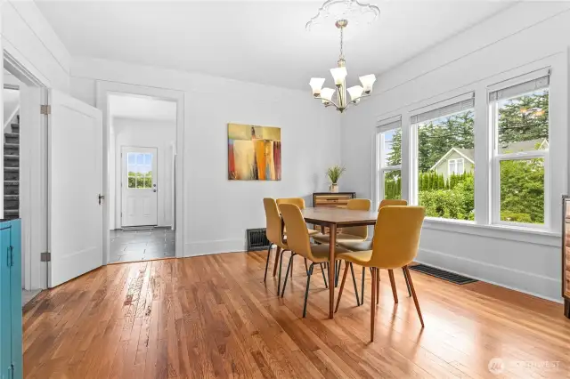 Dining room with open door leading to the kitchen.  The closed door straight ahead leads to the back deck.