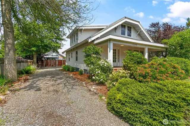 There are two entrances to the home and the driveway wraps around the back of the house.