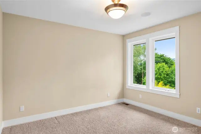 4rd bedroom with large east facing windows. wake up to the Cascade mountains