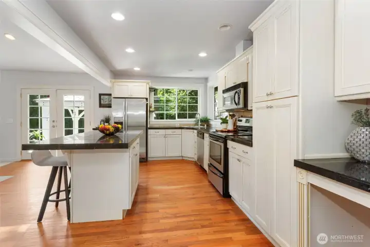 Large kitchen with spacious island.  All appliances stay with home.  French doors go out to backyard
