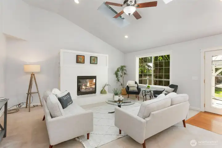 Spacious family room, with ceiling fan, skylights, gas fireplace, vaulted ceilings..open concept style