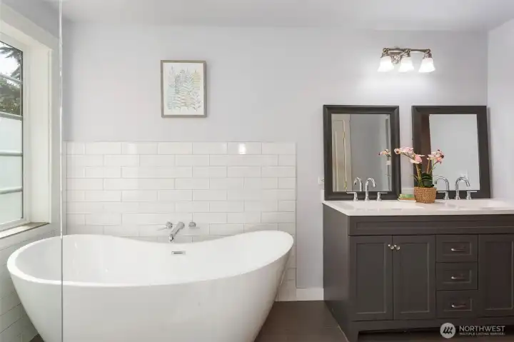 Ah.  This master bathroom was just remodeled with a freestanding soaking tub, large glass shower, water closet and master closet in back