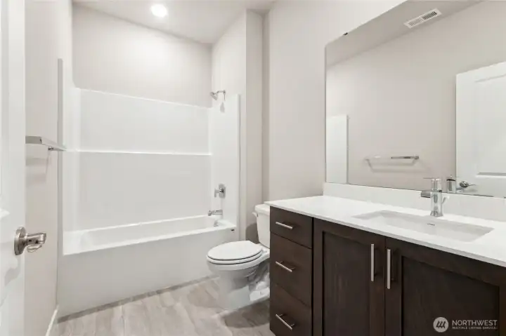 Hall bathroom. Photo rendering is representational. Actual home is under construction and finishes, elevation, and paint colors may vary. See site agent for details.