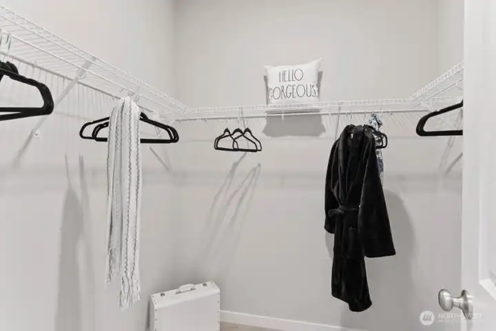 Two walk in closets in the primary bedroom. Photo rendering is representational. Actual home is under construction and finishes, elevation, and paint colors may vary. See site agent for details.