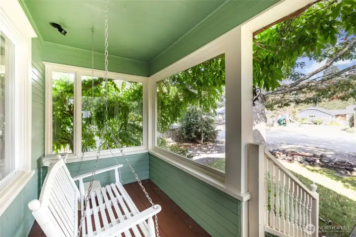 Cozy covered front porch that invites you to sit back & relax all year long!