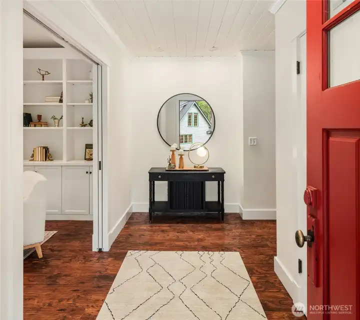Formal entry greats guests, a sumptuous den, left, and entry closets, right.
