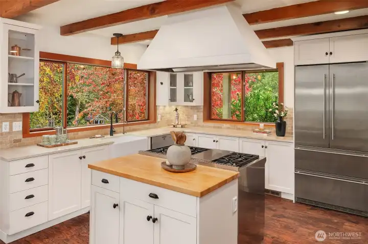 The open concept kitchen boasts high end appliances and smart design. Stay a part of the conversation as friends and family linger in the heart of the home.