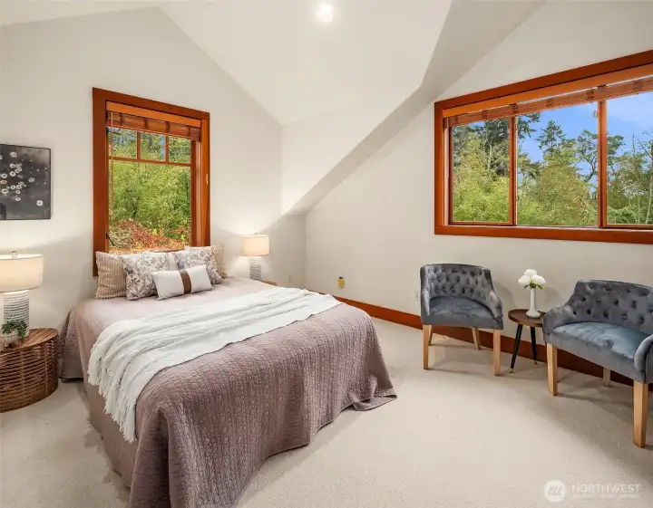 Upstairs bedroom 1. These bedrooms are not overlooked: spacious, featuring vaulted ceilings and corner windows.