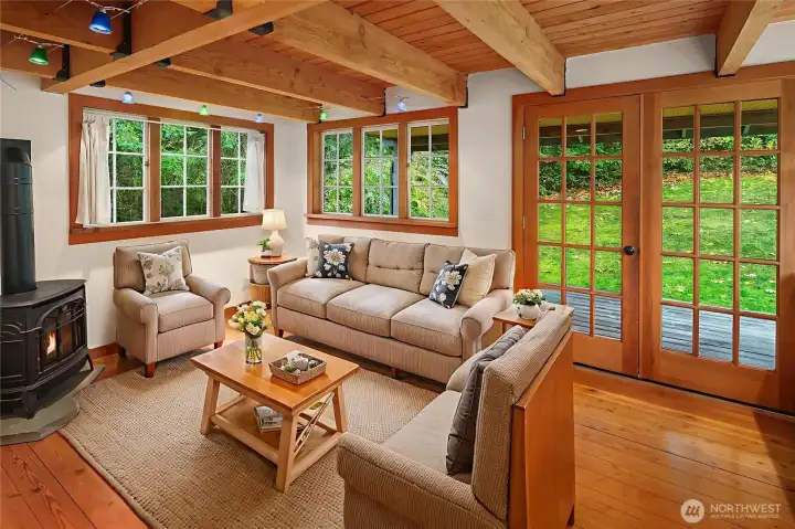 Exposed beams, wood framed windows, and a romantic gas fireplace.