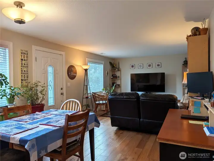 Living room and dining area with gleaming wood floors
