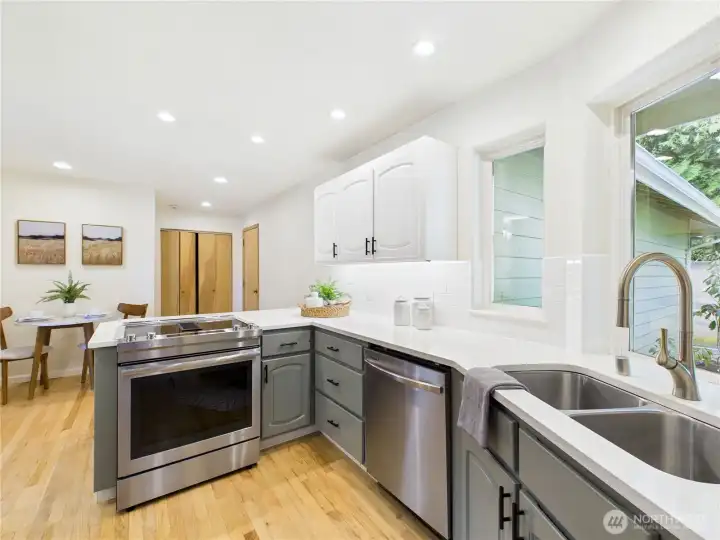 Incredibly cheerful kitchen with a little nook for breakfast or a desk area.  Door on the right leads to the garage. the double doors ahead contain the washer and dryer.