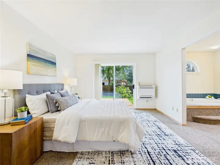 Primary bedroom with sliding door out to the deck area. Again, here is the mini split for heating and cooling.