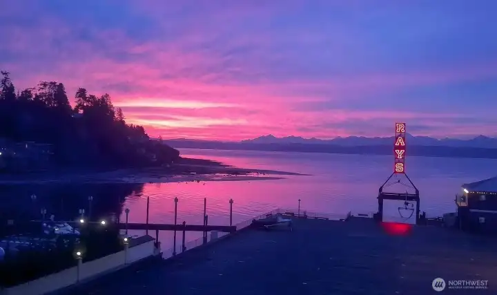 Wow!  How about that sunset! Enjoy amazing views every day from this fabulous top floor corner unit. Super location just across the street from Puget Sound and Seattle landmark restaurant Rays Boathouse.