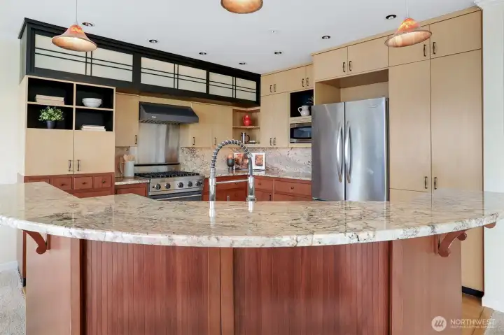 Stylish breakfast bar with a beautiful granite countertop on the kitchen island.