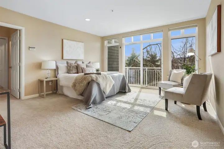 The primary bedroom suite is very spacious and has its own balcony.