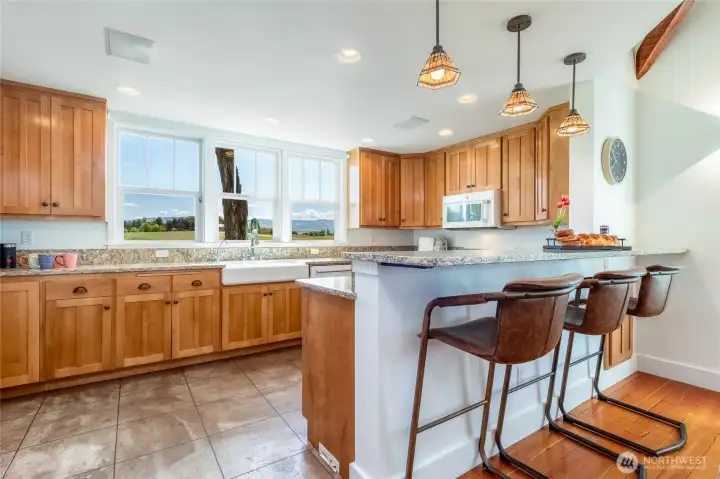 Stamped-concrete floor with radiant heat, farm sink, gas range.