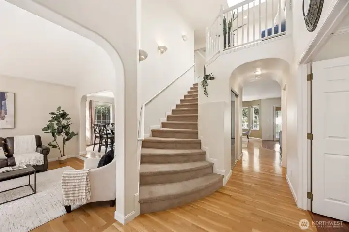 Step into the grand two-story foyer and immediately be impressed by architectural archways and rich hardwood flooring.