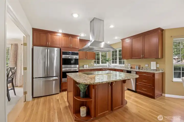 Stainless steel appliances featuring a double oven, perfect for holiday events, highlight the kitchen and are all included in the sale of the home.