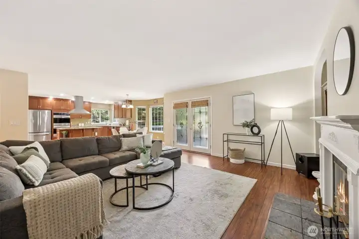 Handsome dark, rich wood flooring in the family room complements the kitchen cabinetry beautifully and is pleasing to the eye. French doors step out to the deck maximizing your entertainment space.