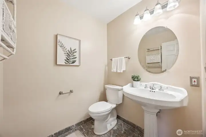 Charming main-level powder room offers both convenience and style for guests and everyday use.