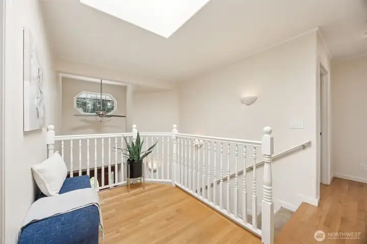 Large upper-level landing continues with hardwood flooring and overlooks the grand foyer.