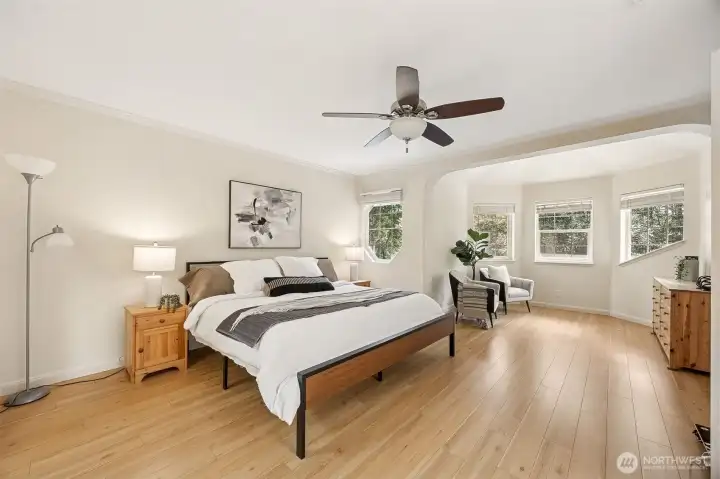 Presenting the primary suite, your own personal retreat that is light and airy and inviting, boasting of wide planked flooring and a soft neutral pallet. Enjoy the sitting area perfect for reading or relaxing.