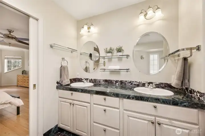 Luxurious en-suite bath offers a large double sink vanity, loads of storage space and exquisite lighting and mirrors.