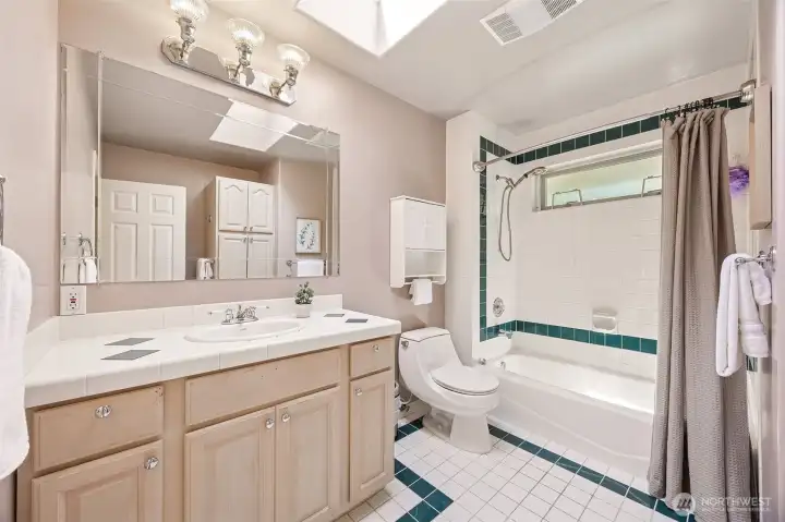 Full main bath serving bedrooms two, three and four is both spacious and stylish with lovely custom tile.