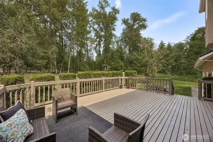 Huge entertainment size deck with plenty of room for outdoor seating, BBQ grill and dining table while enjoying complete privacy and lush green views.
