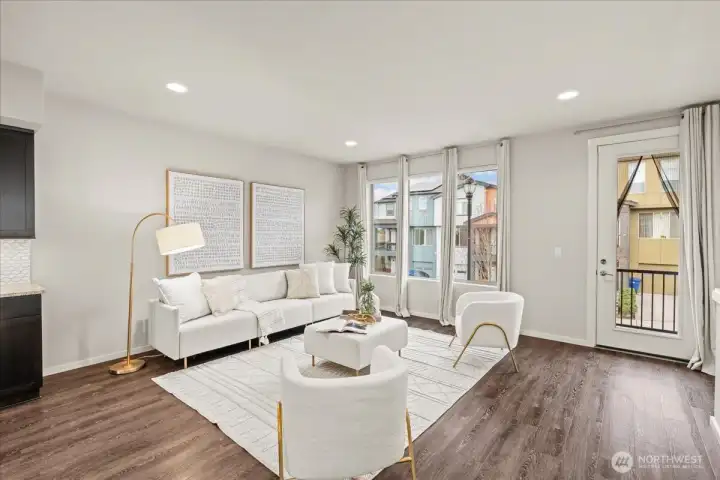 Living Room with large windows, and LVP flooring. Bright and open layout offers comfortable space for everyday living.