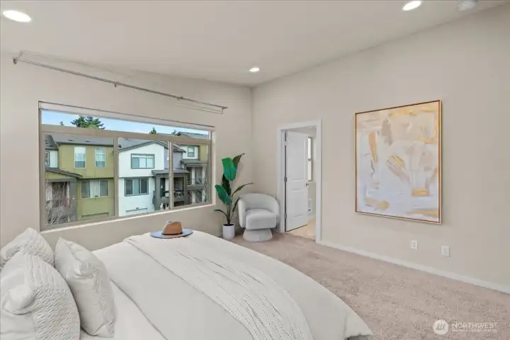 Primary Bedroom alternate view showcasing open floor space and direct access to the en-suite bathroom.