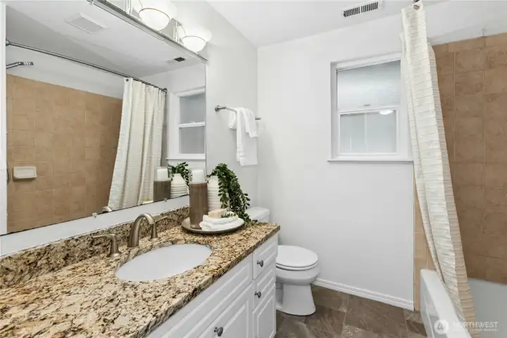 Upstairs shared full bath with new flooring and paint!