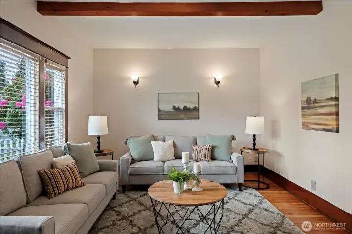 Large windows let afternoon sunlight into the living room