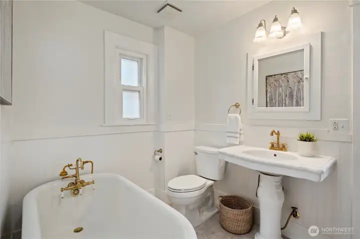 Updated main floor bathroom with vintage charm and a clawfoot tub