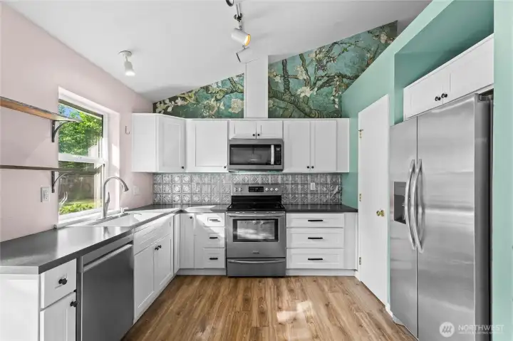Another view of kitchen with Pantry door to the right.Tons of natural light comes into every room.